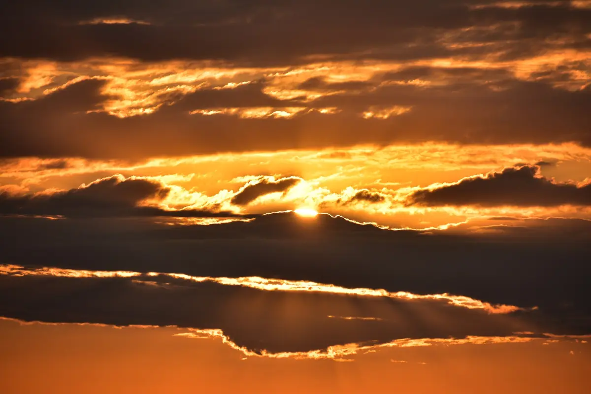 Orange sunset over the Rufiji River with layered clouds